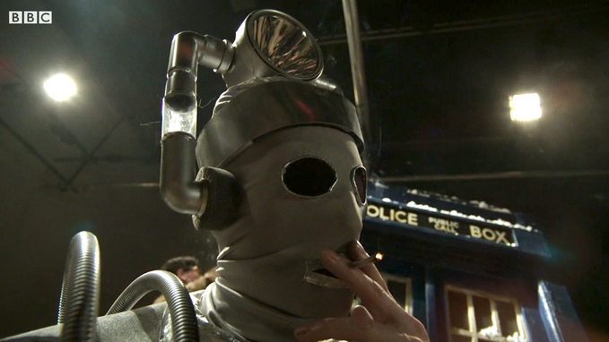 A Cyberman grabs a smoke break on the set of DOCTOR WHO (AN ADVENTURE IN SPACE AND TIME).