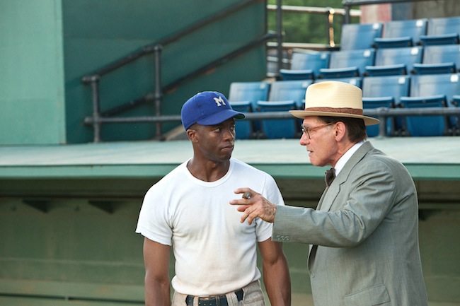 Chadwick Boseman as Jackie Robinson and Harrison Ford as Branch Rickey in 42. 