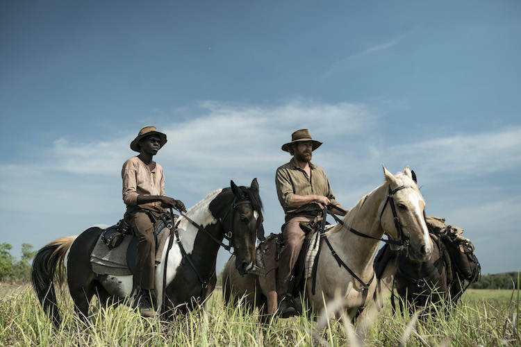 [L-R] Jacob Junior Nayinggul as Gutjuk and Simon Baker as Travis in the adventure/drama film, HIGH GROUND, a Samuel Goldwyn Films release. Photo Courtesy of Samuel Goldwyn Films.