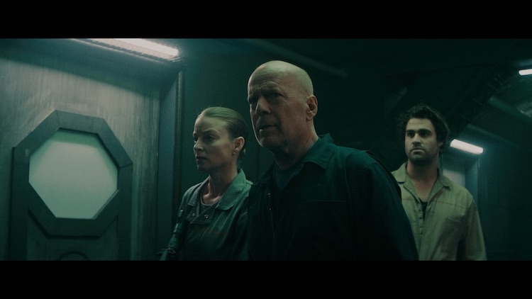 (L - R) Rachel Nichols as Chambers, Bruce Willis as Clay Young, and Cody Kearsley as Noah in the sci - fi/action film , BREACH , a Saban Films release. Photo courtesy of Saban Films.