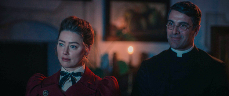 [L-R] – Amber Heard as Grace Burnham and Luca Calvani as Father Antonio in the thriller, IN THE FIRE, a Saban Films release. Photo courtesy of Saban Films.