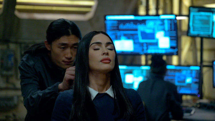 [L-R] Kexin Wang as “John” and Megan Fox as “Alice” in the Sci-Fi/Thriller, SUBSERVIENCE, an XYZ Films release. Photo courtesy of XYZ Films. 