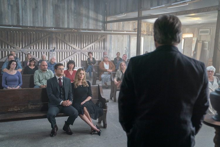 (L-R in front pew) Finn Jones as Robert and Jessica McNamee as Maia in the Psychological Horror/Thriller film, THE VISITOR, a Paramount Home Entertainment and EPIX release. Photo courtesy of Sam Lothridge and Blumhouse Television.  